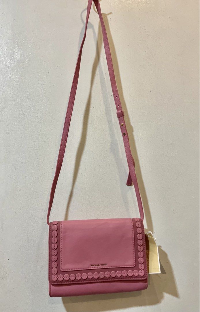 Michael Kors Pink Leather Wallet with Strap (Category: Wallets & Card holders) located in Bacolod City. Submitted by vintage_vogue6100 (Listing ID 1463385206, Image 3). Description: - Genuine pink Michael Kors wallet - Premium leather with elegant scalloped edge detail - Versatile long strap for crossbody wear - Ample card slots and secure zip pocket inside - Stylish gold hardware - Comes with original tag, brand new.