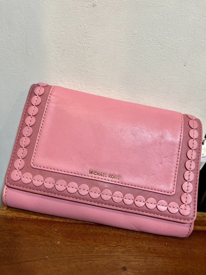 Michael Kors Pink Leather Wallet with Strap (Category: Wallets & Card holders) located in Bacolod City. Submitted by vintage_vogue6100 (Listing ID 1463385206, Image 1). Description: - Genuine pink Michael Kors wallet - Premium leather with elegant scalloped edge detail - Versatile long strap for crossbody wear - Ample card slots and secure zip pocket inside - Stylish gold hardware - Comes with original tag, brand new.