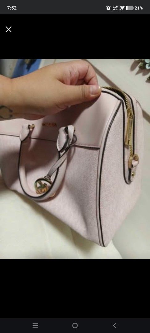 Michael Kors Pink Monogrammed Satchel Bag (Category: Luxury Bags & Wallets) located in Cabanatuan. Submitted by laizamhar22 (Listing ID 1463455459, Image 3). Description: - Michael Kors satchel bag - Light pink color - All-over MK monogram pattern - Gold hardware details - Top zip closure - Double handles - Ideal for everyday use and carrying essentials.