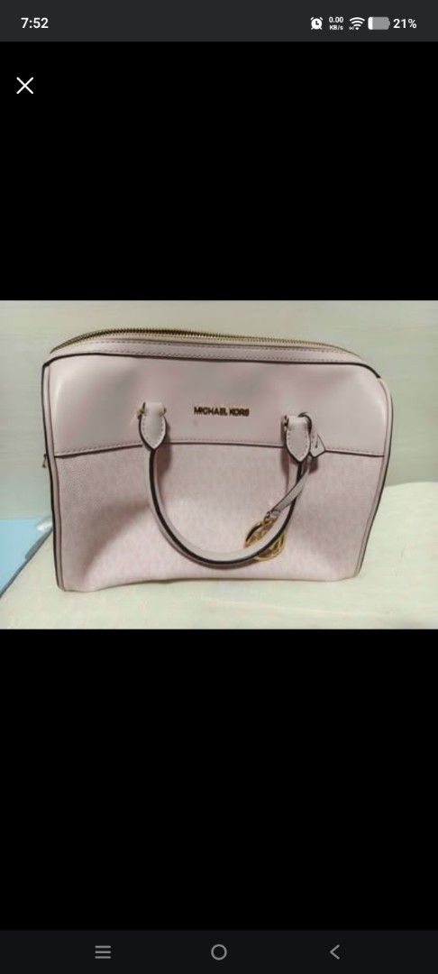 Michael Kors Pink Monogrammed Satchel Bag (Category: Luxury Bags & Wallets) located in Cabanatuan. Submitted by laizamhar22 (Listing ID 1463455459, Image 1). Description: - Michael Kors satchel bag - Light pink color - All-over MK monogram pattern - Gold hardware details - Top zip closure - Double handles - Ideal for everyday use and carrying essentials.