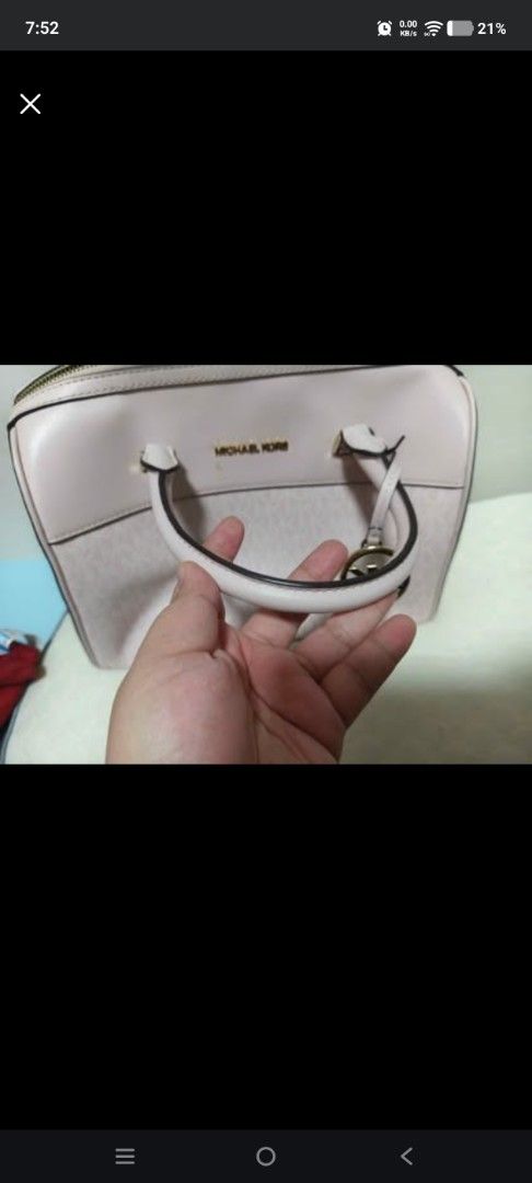 Michael Kors Pink Monogrammed Satchel Bag (Category: Luxury Bags & Wallets) located in Cabanatuan. Submitted by laizamhar22 (Listing ID 1463455459, Image 2). Description: - Michael Kors satchel bag - Light pink color - All-over MK monogram pattern - Gold hardware details - Top zip closure - Double handles - Ideal for everyday use and carrying essentials.