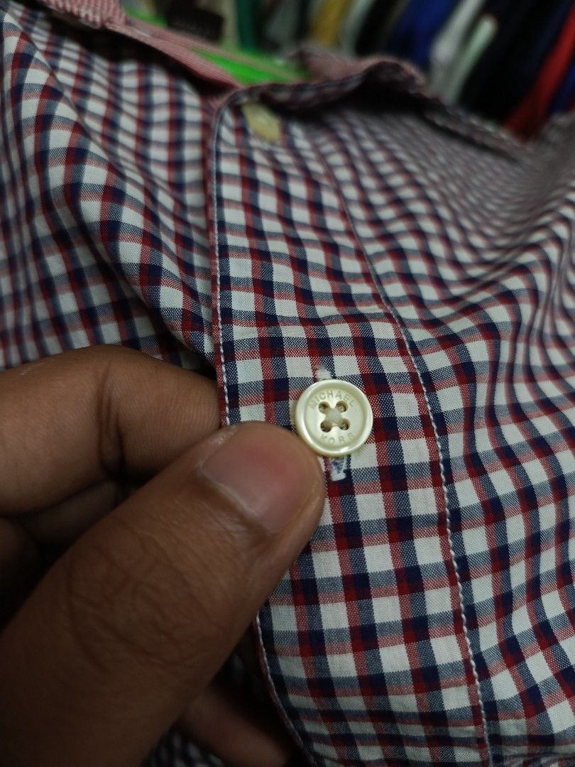 Michael Kors Tailored Fit Gingham Shirt Size M (Category: Tshirts & Polo Shirts ) located in Cabatuan. Submitted by penthegreat (Listing ID 1463472650, Image 3). Description: - Michael Kors Button-Up Shirt - Classic Gingham Pattern (Navy & Red) - Tailored Fit - Size: Medium (M) - Versatile for Casual or Smart-Casual Occasions - Easy to Style with Jeans or Trousers.