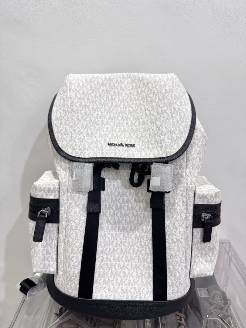 Michael Kors White MK Signature Logo Backpack (Category: Backpacks) located in Makati City. Submitted by jadebello (Listing ID 1463339377, Image 1). Description: - Authentic White Michael Kors Backpack - Signature MK Logo Print - Stylish Black Trim and Straps - Convenient Side Zip Pockets - Secure Flap Top Closure - Comes in Original Plastic Packaging - Ideal for Everyday Use or Travel - Complete Tag / Never been used.