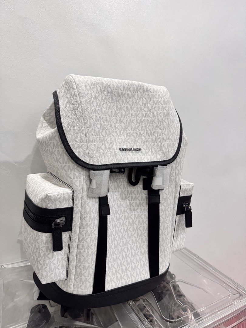 Michael Kors White MK Signature Logo Backpack (Category: Backpacks) located in Makati City. Submitted by jadebello (Listing ID 1463339377, Image 2). Description: - Authentic White Michael Kors Backpack - Signature MK Logo Print - Stylish Black Trim and Straps - Convenient Side Zip Pockets - Secure Flap Top Closure - Comes in Original Plastic Packaging - Ideal for Everyday Use or Travel - Complete Tag / Never been used.