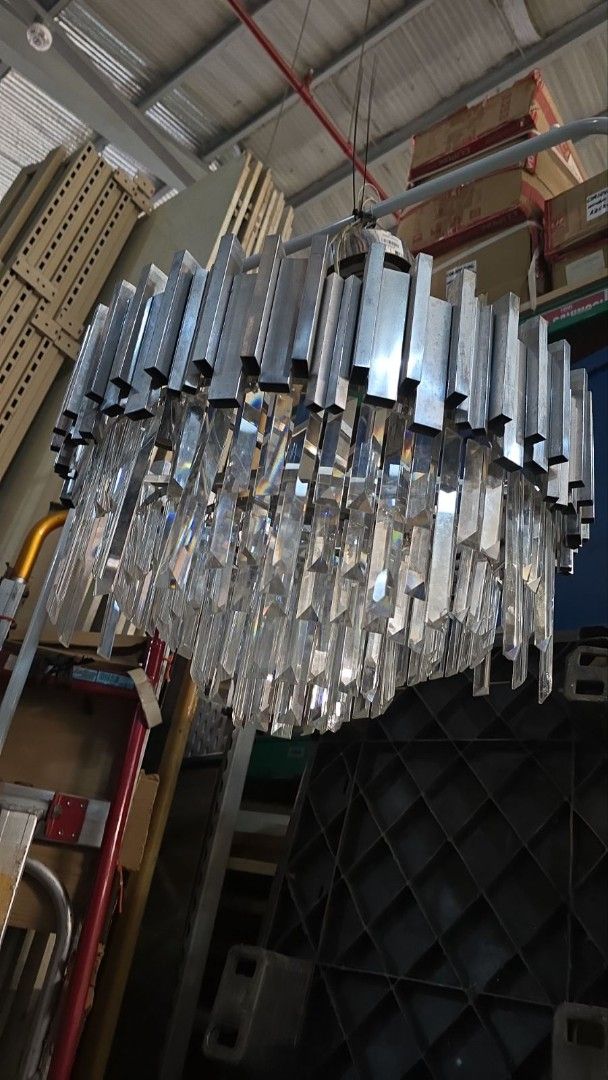 Modern Crystal and Metal Chandelier (Category: Lighting) located in Cainta. Submitted by christine07. (Listing ID 1463327093, Image 1). Description: - Modern chandelier design - Features clear crystal droplets - Brushed metal accents - Adds sophistication and ambiance - Ready for installation - Ideal for dining rooms and living areas.