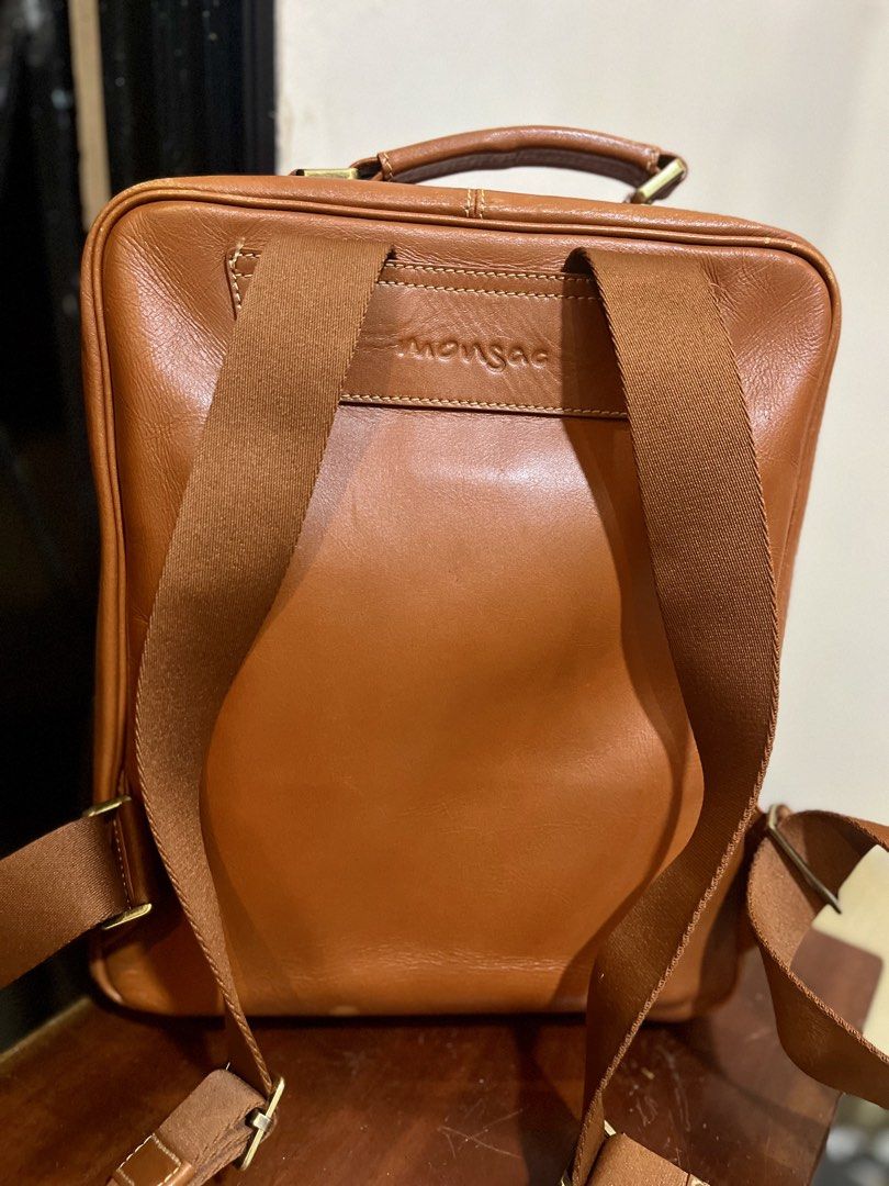 MONSAC Brown Leather Backpack (Category: Backpacks) located in Bacolod City. Submitted by vintage_vogue6100 (Listing ID 1463379884, Image 2). Description: - Genuine brown leather MONSAC backpack - Spacious main compartment with internal pockets - Additional zip pocket inside main compartment - Convenient front zip pocket for quick access - Adjustable shoulder straps for a comfortable fit - Sturdy top handle for alternative carrying - Ideal for ev