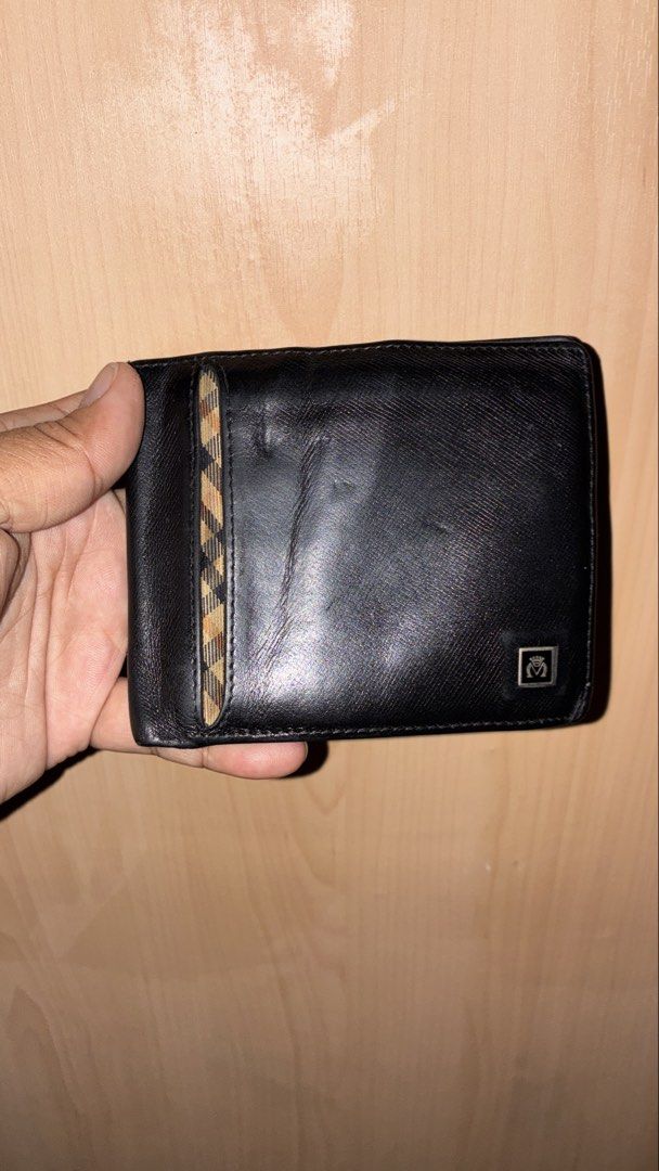 Moritz Black Leather Bifold Wallet (Category: Luxury Bags & Wallets) located in Placer. Submitted by talaalond61563 (Listing ID 1463339058, Image 1). Description: - Genuine Moritz leather bifold wallet - Multiple card slots for organization - Clear ID window for easy access - Shows some signs of wear on the leather, consistent with use - Still in good overall condition.