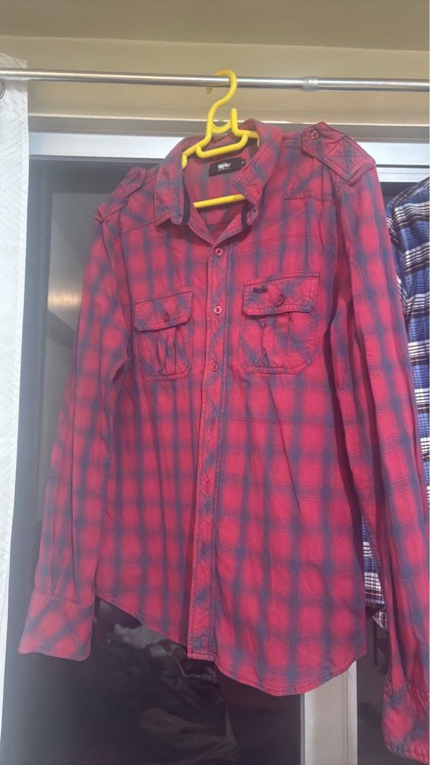Mossimo Red Plaid Flannel Shirt (Category: Tshirts & Polo Shirts ) located in Quezon City. Submitted by zealfox-17 (Listing ID 1463498358, Image 1). Description: - Classic red and navy plaid flannel shirt - Brand: Mossimo - Button-up front - Two chest pockets - Shoulder epaulets for a rugged look - Versatile for layering or wearing alone - Comfortable and stylish design.
