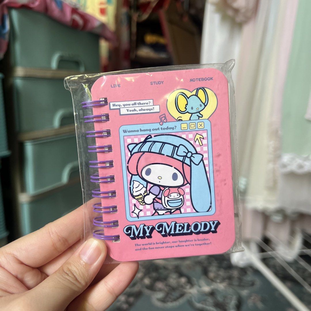 My Melody Mini Notebook Spiral Bound Sanrio (Category: Stationery & School Supplies) located in Quezon City. Submitted by mei_declutters (Listing ID 1463402881, Image 1). Description: - Adorable My Melody notebook with a pink cover. - Features My Melody and a cute little mouse design. - Spiral-bound for easy page flipping. - Ideal for taking notes or drawing doodles. - Compact and portable size for on-the-go use. - Authentic Sanrio licensed produ