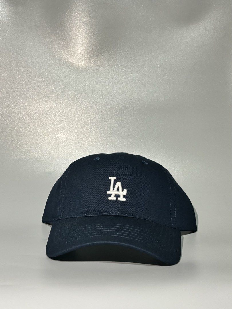 Navy Blue MLB LA Dodgers Baseball Cap (Category: Caps & Hats) located in Manila. Submitted by gilmorecapz (Listing ID 1463441230, Image 1). Description: - Classic navy blue LA Dodgers cap - Features iconic LA Dodgers logo - Adjustable strap for a comfortable, custom fit - MLB branding on the inside and back - Ideal for everyday wear and showing team pride - Simple, stylish, and versatile.