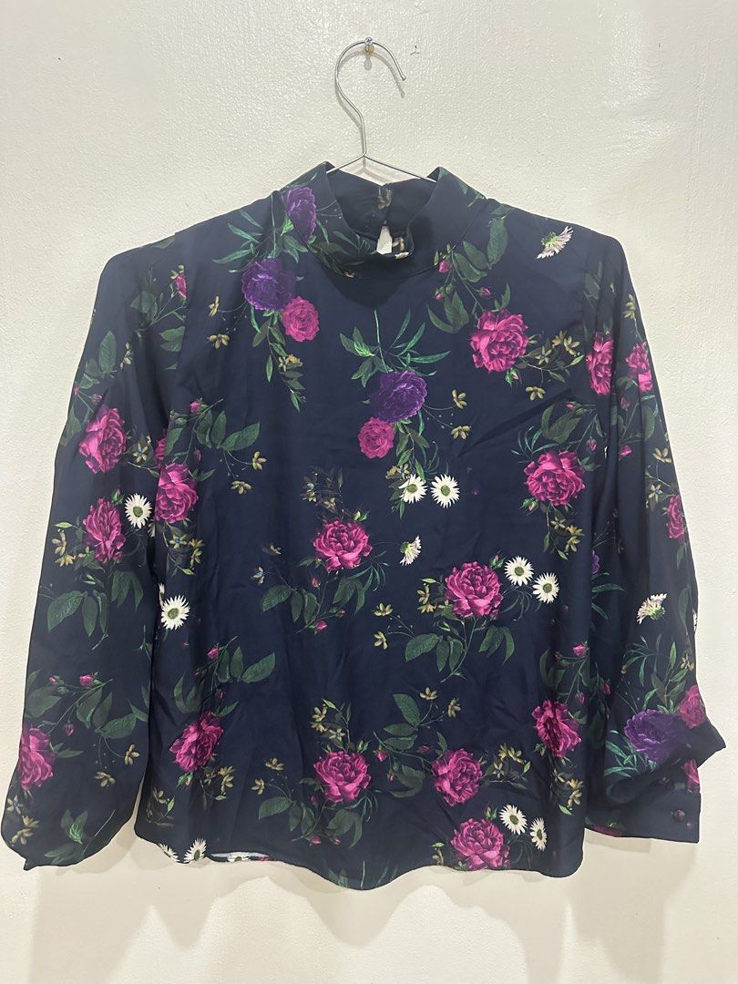 Navy Floral Mock Neck Long Sleeve Blouse Medium (Category: Blouses) located in Manila. Submitted by roseluxuryitems (Listing ID 1463474097, Image 1). Description: - Navy blue long sleeve blouse - Beautiful floral print with pink & purple roses and white daisies - Mock neck design - Button closure at the back - Cuffed sleeves with button detail - Perfect for dressing up or down.