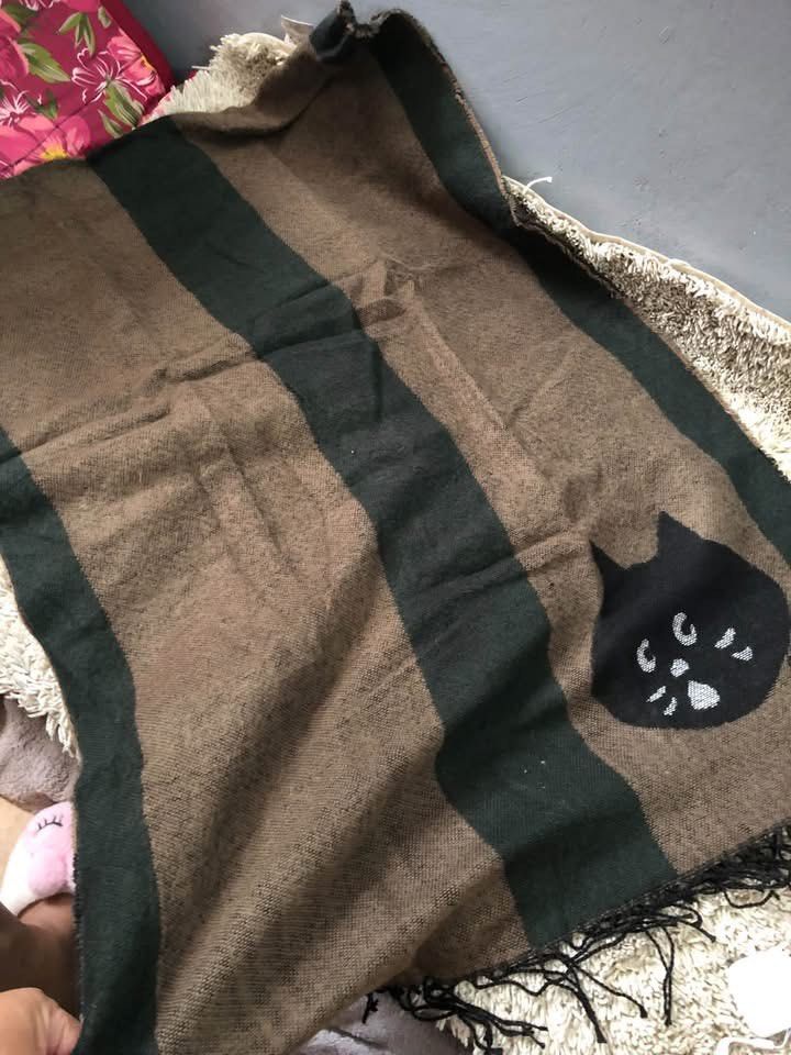 Ne-net Long Scarf (Category: Scarves) located in Baguio. Submitted by pasabuy_999 (Listing ID 1463550207, Image 3). Description: - Cozy scarf with a cute black cat face design. - Features stylish brown and dark green stripes. - Adorned with fringe details on the edges. - Generously sized for comfortable wrapping. - Ideal for cooler weather. - Adds a fun and playful accent to any outfit..