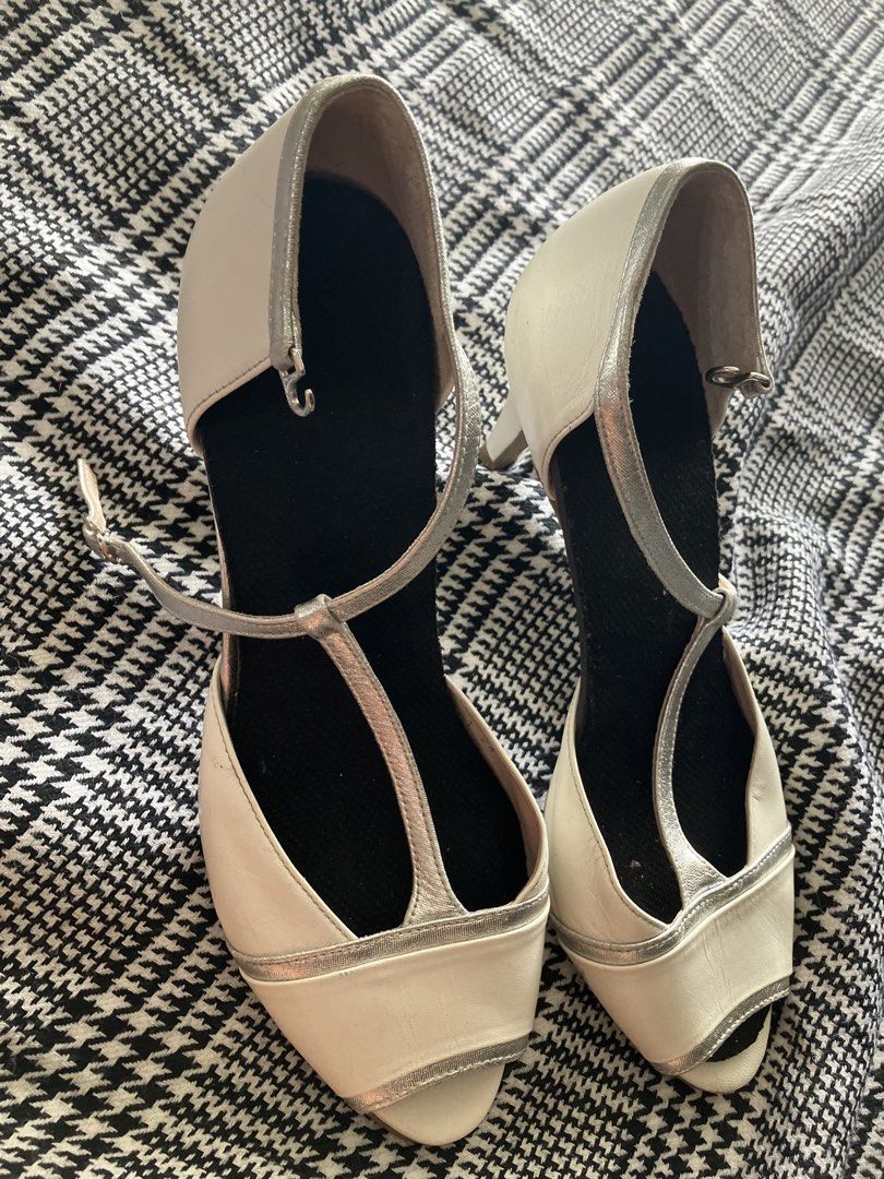 Neorhythm t-strap peep toe heels (Category: Heels) located in Angeles City. Submitted by jnwsurplus (Listing ID 1463365494, Image 2). Description: These appear to be cream and metallic silver T-strap peep-toe heels featuring a delicate buckled ankle strap and subtle contrast piping..
