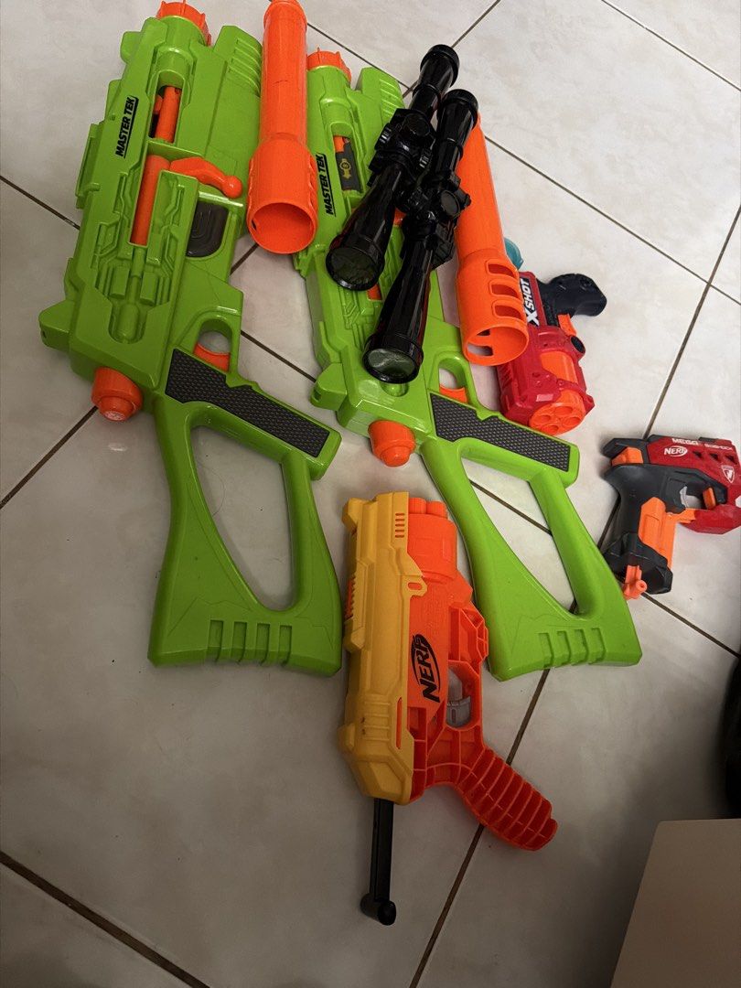 Nerf and X-Shot Toy Guns Bundle (Category: Action & Battle Toys) located in Pasig City. Submitted by emckjtze (Listing ID 1463331778, Image 1). Description: - Bundle of toy guns perfect for playtime! - Includes several large green Master Tek blasters. - Features a yellow and orange Nerf N-Strike Elite Strongarm. - Comes with a red X-Shot gun. - Also includes a black and orange Nerf gun. - Some guns come with attached scopes..