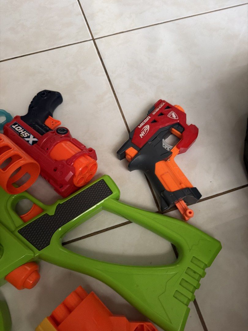 Nerf and X-Shot Toy Guns Bundle (Category: Action & Battle Toys) located in Pasig City. Submitted by emckjtze (Listing ID 1463331778, Image 2). Description: - Bundle of toy guns perfect for playtime! - Includes several large green Master Tek blasters. - Features a yellow and orange Nerf N-Strike Elite Strongarm. - Comes with a red X-Shot gun. - Also includes a black and orange Nerf gun. - Some guns come with attached scopes..