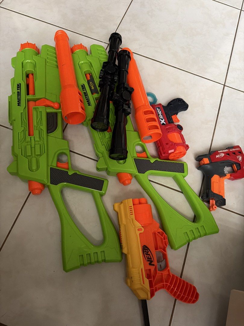 Nerf and X-Shot Toy Guns Bundle (Category: Action & Battle Toys) located in Pasig City. Submitted by emckjtze (Listing ID 1463331778, Image 3). Description: - Bundle of toy guns perfect for playtime! - Includes several large green Master Tek blasters. - Features a yellow and orange Nerf N-Strike Elite Strongarm. - Comes with a red X-Shot gun. - Also includes a black and orange Nerf gun. - Some guns come with attached scopes..