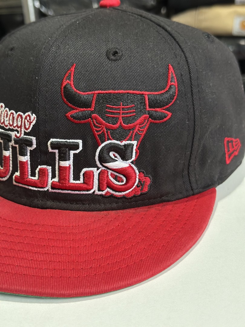 New Era Chicago Bulls NBA Snapback Cap (Category: Caps & Hats) located in Daet. Submitted by thrifthings2018 (Listing ID 1463423977, Image 3). Description: - Authentic Chicago Bulls snapback cap - Classic black and red colorway - Features the iconic Bulls logo and 'Chicago Bulls' text on the front - 'Family' embroidered on the back - New Era branding - Ideal for any basketball and Bulls fan.