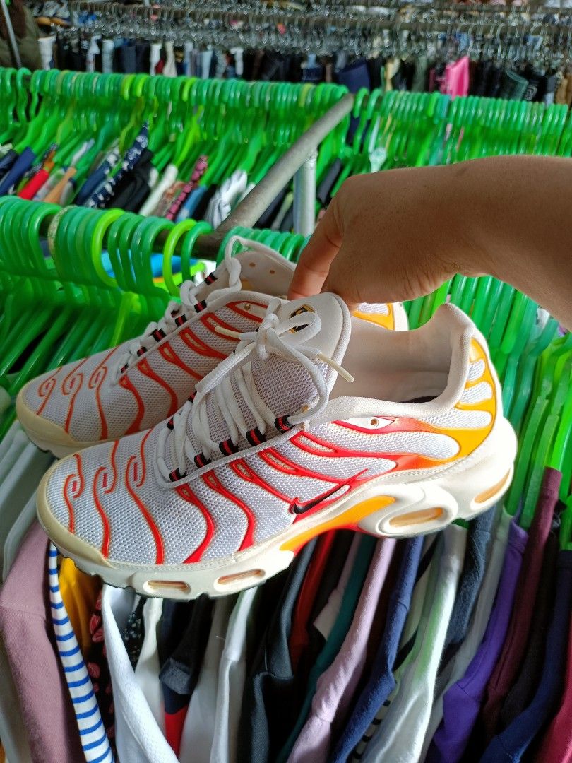 Nike Air Max Plus TN SE White Orange Yellow (Category: Sneakers) located in Manila. Submitted by pnjdianne25879 (Listing ID 1463430194, Image 2). Description: - White Nike Air Max Plus TN SE sneakers - Iconic red and orange wavy design lines - Yellow accents on heel and sole - Features Air Max cushioning for comfort - Lace-up closure - Perfect for everyday wear or athletic activities.