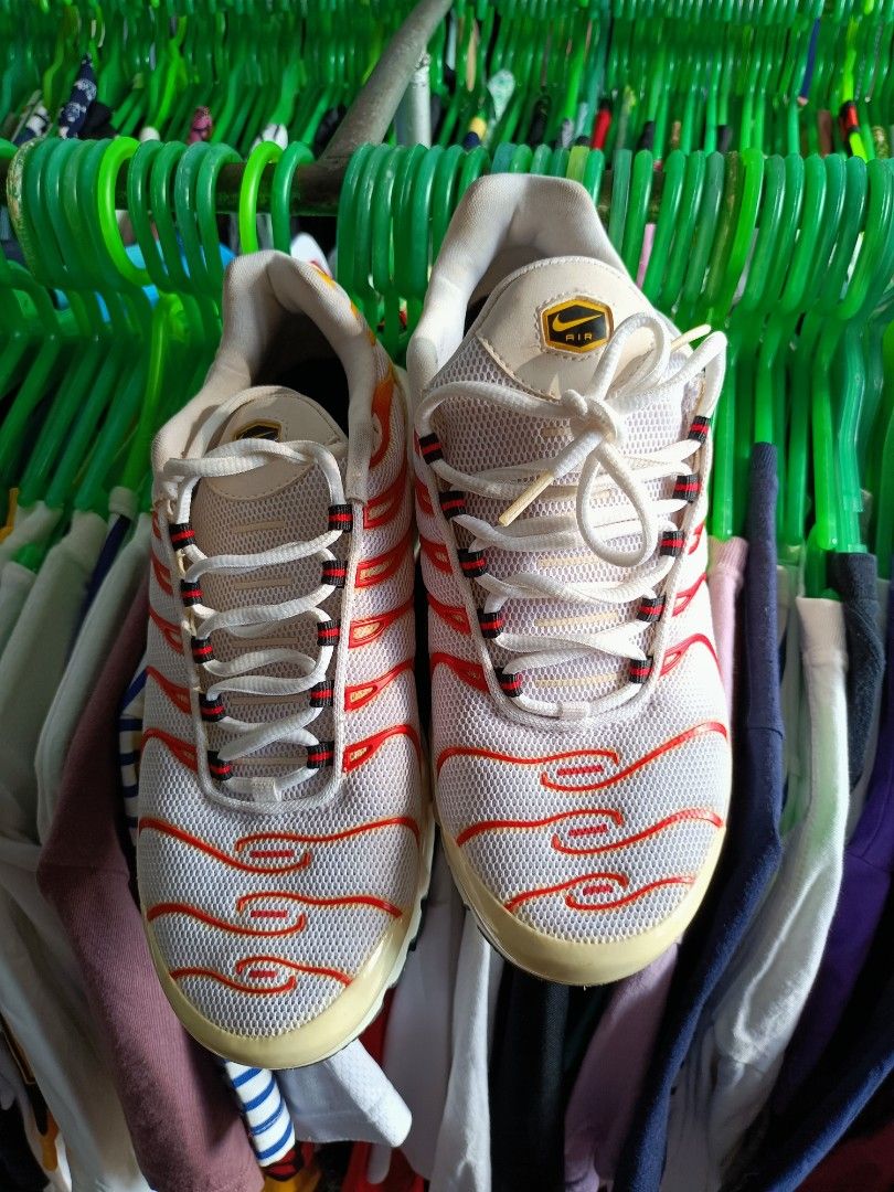 Nike Air Max Plus TN SE White Orange Yellow (Category: Sneakers) located in Manila. Submitted by pnjdianne25879 (Listing ID 1463430194, Image 3). Description: - White Nike Air Max Plus TN SE sneakers - Iconic red and orange wavy design lines - Yellow accents on heel and sole - Features Air Max cushioning for comfort - Lace-up closure - Perfect for everyday wear or athletic activities.