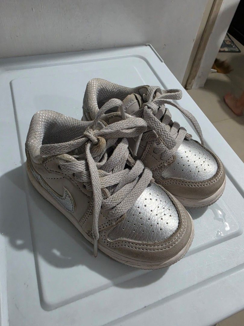 Nike Jordan 1 Low Shoes Toddler Silver (Category: Babies & Kids Fashion) located in Manila. Submitted by shieladmd (Listing ID 1463432021, Image 2). Description: - Cute baby Nike Jordan 1 Low shoes - Silver color with white soles - Lace-up closure - Ideal for babies learning to walk or for style - Shows some signs of wear, but still in good usable condition - Perfect for little sneakerheads.