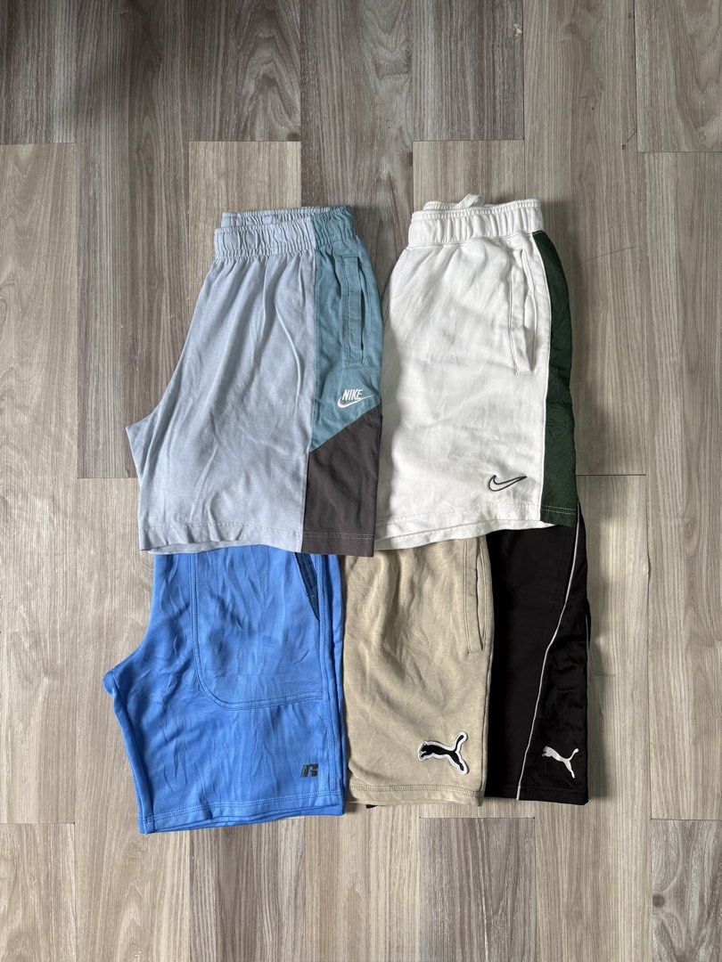 Nike, Puma, Russell Athletic Shorts Bundle (Category: Shorts) located in Rizal. Submitted by thriftdrip.402 (Listing ID 1463495852, Image 1). Description: - Bundle of 5 pairs of men's shorts - Brands include Nike, Puma, and Russell Athletic - Assorted colors: light blue, white with green, tan, black, and grey/blue/dark grey - Features elastic waistbands on all pairs - Ideal for sports activities or casual everyday wear.