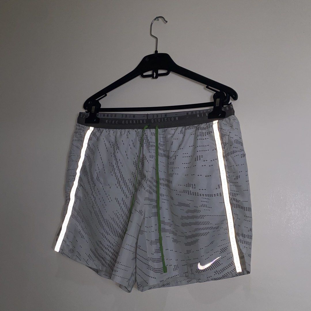 Nike Running Division Shorts M Grey Reflective (Category: Activewear) located in Cebu City. Submitted by theloose.thread (Listing ID 1463363204, Image 1). Description: - Grey Nike running shorts - Size: Medium (M) - Nike Running Division branding on waistband - Adjustable drawstring for a secure fit - Reflective strips on sides and back for enhanced visibility.