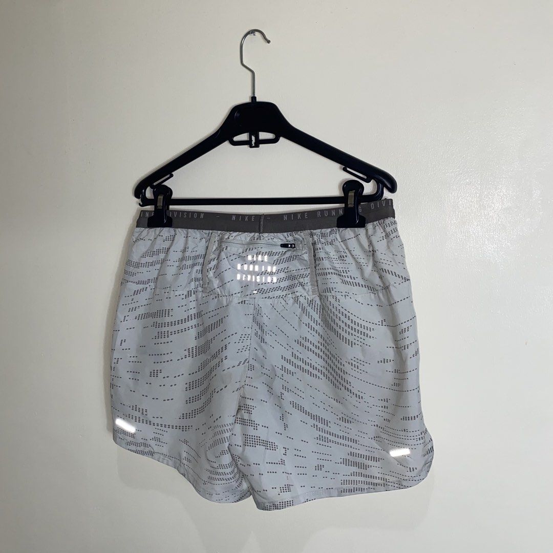 Nike Running Division Shorts M Grey Reflective (Category: Activewear) located in Cebu City. Submitted by theloose.thread (Listing ID 1463363204, Image 2). Description: - Grey Nike running shorts - Size: Medium (M) - Nike Running Division branding on waistband - Adjustable drawstring for a secure fit - Reflective strips on sides and back for enhanced visibility.