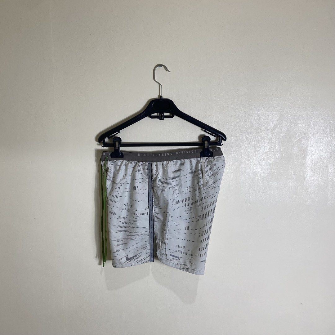 Nike Running Division Shorts M Grey Reflective (Category: Activewear) located in Cebu City. Submitted by theloose.thread (Listing ID 1463363204, Image 3). Description: - Grey Nike running shorts - Size: Medium (M) - Nike Running Division branding on waistband - Adjustable drawstring for a secure fit - Reflective strips on sides and back for enhanced visibility.