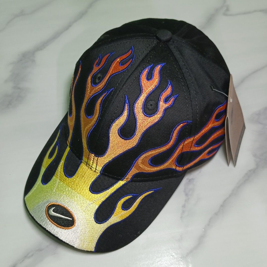 Nike Structured OG Flame Club Cap (High quality Replica) (Category: Caps & Hats) located in Dasmarinas. Submitted by nifty_n00k (Listing ID 1463327120, Image 1). Description: - Black Nike cap - Unique flame embroidery design (yellow, orange, red with blue outlines) - Features the classic Nike swoosh logo - Brand new with original tags attached - Adds a stylish flair to any outfit.