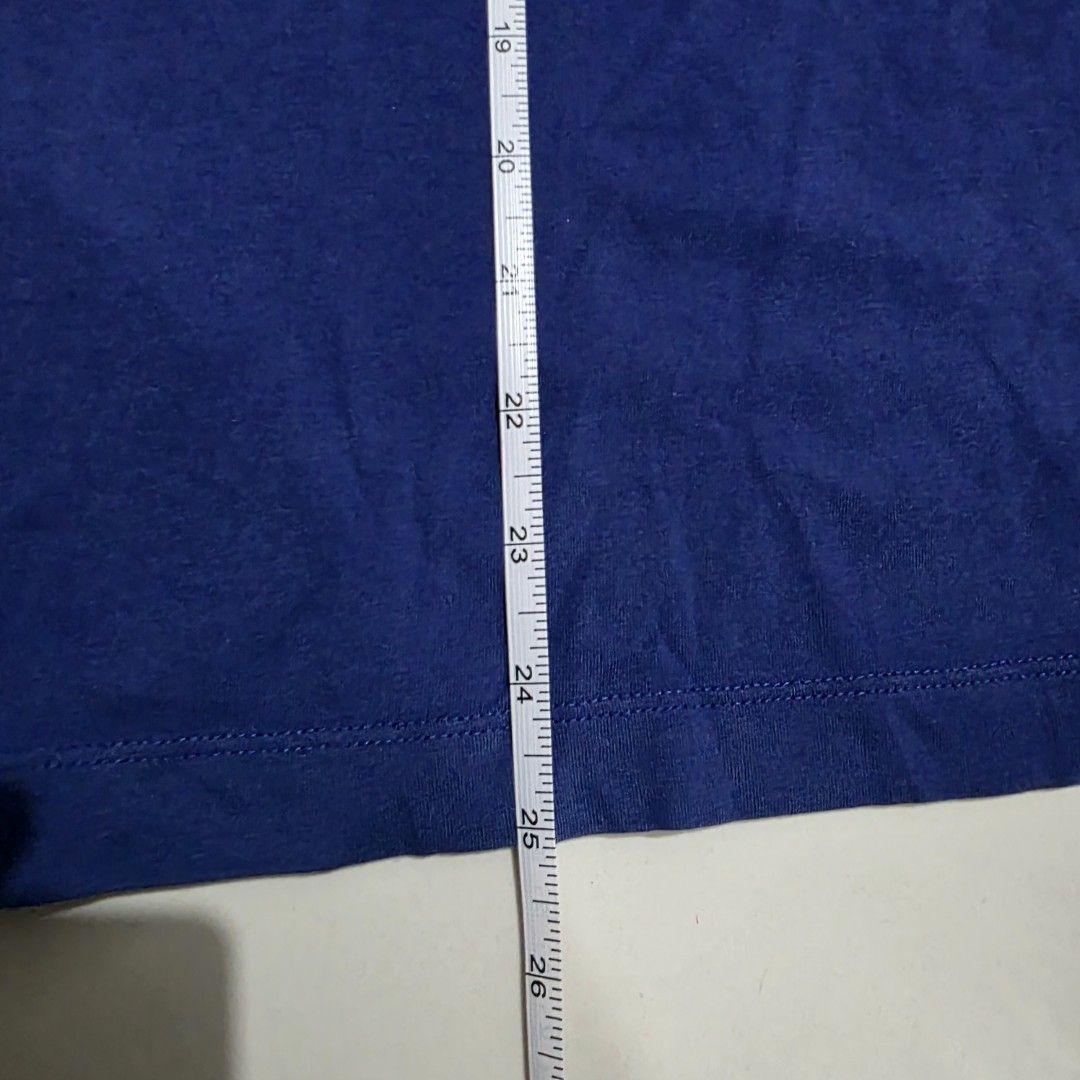 Nike Swoosh T-shirt Blue (Category: Tshirts & Polo Shirts ) located in Quezon City. Submitted by kick_mnl (Listing ID 1463374743, Image 3). Description: - Blue Nike T-Shirt - Large white Swoosh logo with vertical 'SWOOSH' text - 'THE NIKE TEE' printed on the inside collar - Approximate Measurements: 24" chest, 17" shoulder to hem - Ideal for casual everyday wear.