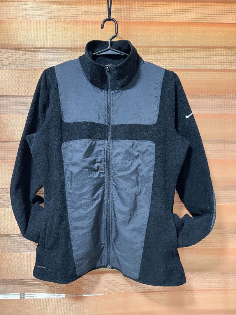 Nike Therma-Fit Fleece Jacket Black (Category: Coats, Jackets and Outerwear) located in Makati City. Submitted by rexb1993 (Listing ID 1463494548, Image 1). Description: - Black Nike Therma-Fit fleece jacket - Contrasting grey panels on front and sleeves - Full zip closure - Stand-up collar - Ideal for layering or as a standalone piece - Shows some signs of wear on the fleece material.