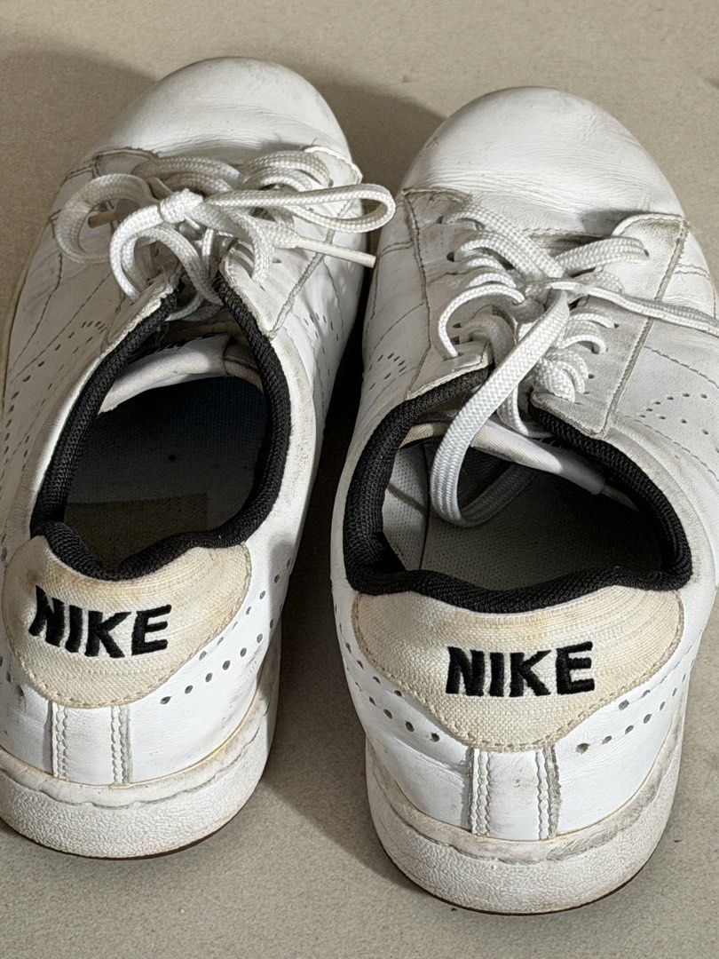 Nike White Leather Sneakers (Category: Sneakers) located in Taguig. Submitted by anxmz (Listing ID 1463409828, Image 2). Description: - Classic white Nike sneakers - Genuine leather with perforated details - Lace-up closure for a secure fit - Iconic Nike logo on the heel tab - Versatile for everyday casual outfits.