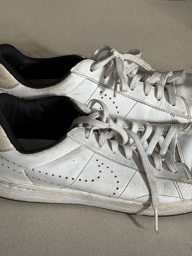 Nike White Leather Sneakers (Category: Sneakers) located in Taguig. Submitted by anxmz (Listing ID 1463409828, Image 3). Description: - Classic white Nike sneakers - Genuine leather with perforated details - Lace-up closure for a secure fit - Iconic Nike logo on the heel tab - Versatile for everyday casual outfits.