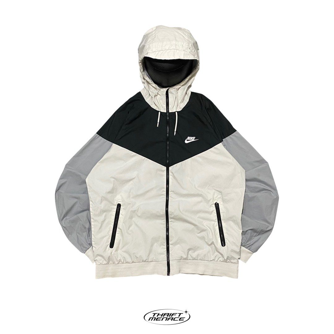 Nike Windrunner Jacket White Black Grey (Category: Coats, Jackets and Outerwear) located in Manila. Submitted by urboycee (Listing ID 1463485921, Image 1). Description: - Classic Nike Windrunner jacket - Iconic chevron design - Colorblocked: White, black, and grey - Lightweight material, ideal for layering - Features a hood - Zippered pockets for secure storage - Perfect for casual wear or light outdoor activities.