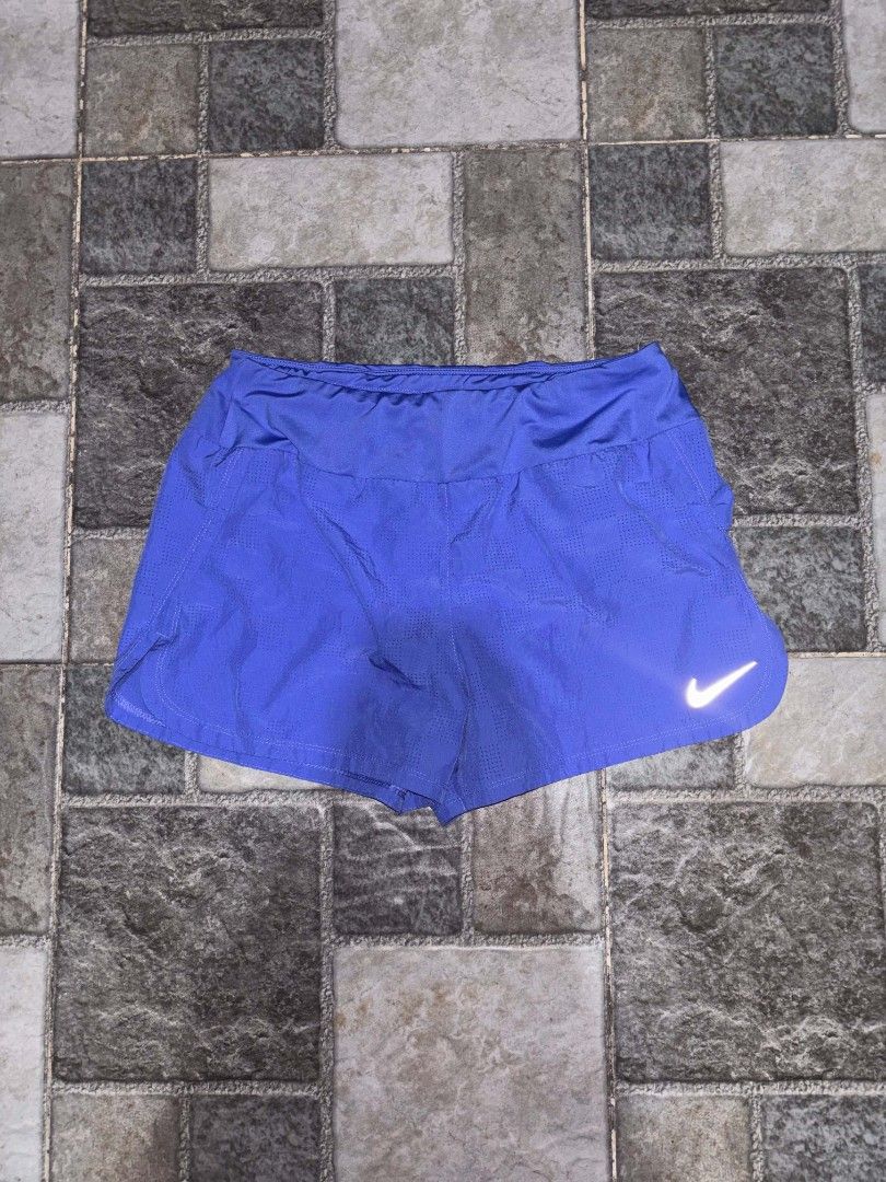 Nike Women's Blue Running Shorts (Category: Activewear) located in Iriga City. Submitted by thrifttobicol29 (Listing ID 1463453621, Image 1). Description: - Blue Nike running shorts for women - Lightweight and breathable fabric - Features the iconic Nike swoosh logo - Elastic waistband for a comfortable fit - Ideal for workouts and casual wear.