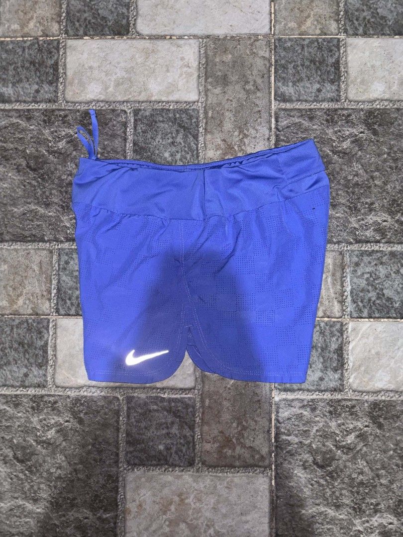 Nike Women's Blue Running Shorts (Category: Activewear) located in Iriga City. Submitted by thrifttobicol29 (Listing ID 1463453621, Image 2). Description: - Blue Nike running shorts for women - Lightweight and breathable fabric - Features the iconic Nike swoosh logo - Elastic waistband for a comfortable fit - Ideal for workouts and casual wear.