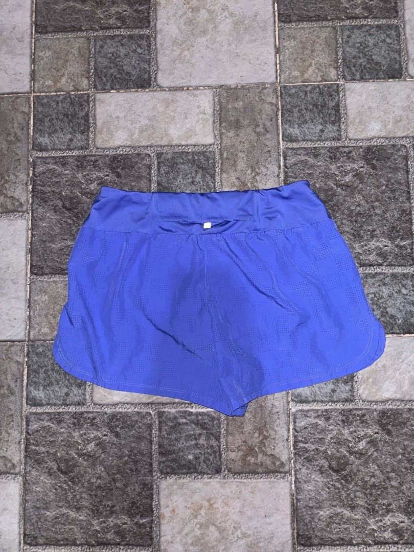 Nike Women's Blue Running Shorts (Category: Activewear) located in Iriga City. Submitted by thrifttobicol29 (Listing ID 1463453621, Image 3). Description: - Blue Nike running shorts for women - Lightweight and breathable fabric - Features the iconic Nike swoosh logo - Elastic waistband for a comfortable fit - Ideal for workouts and casual wear.