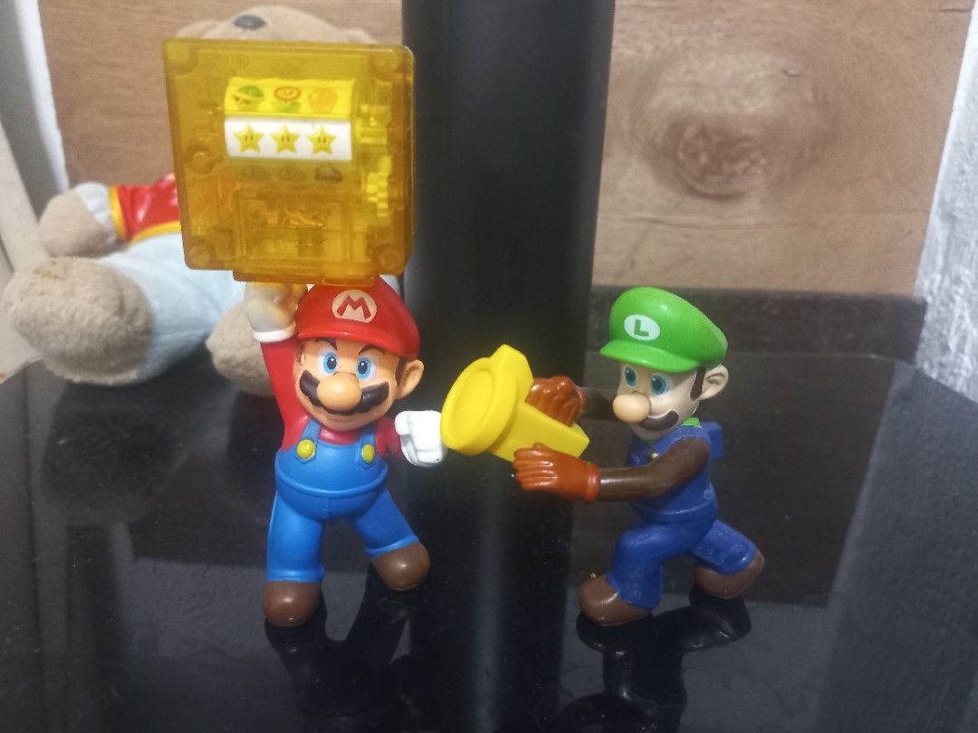 Nintendo Mario & Luigi Figures with Coin Block (Category: Figurines & Statues) located in Manila. Submitted by maryjoyenc89891 (Listing ID 1463379521, Image 1). Description: - Set of collectible Mario and Luigi figurines. - Mario is holding a yellow coin block with stars. - Luigi is holding a yellow item (coin or power-up). - Ideal for any Nintendo fan and collector..