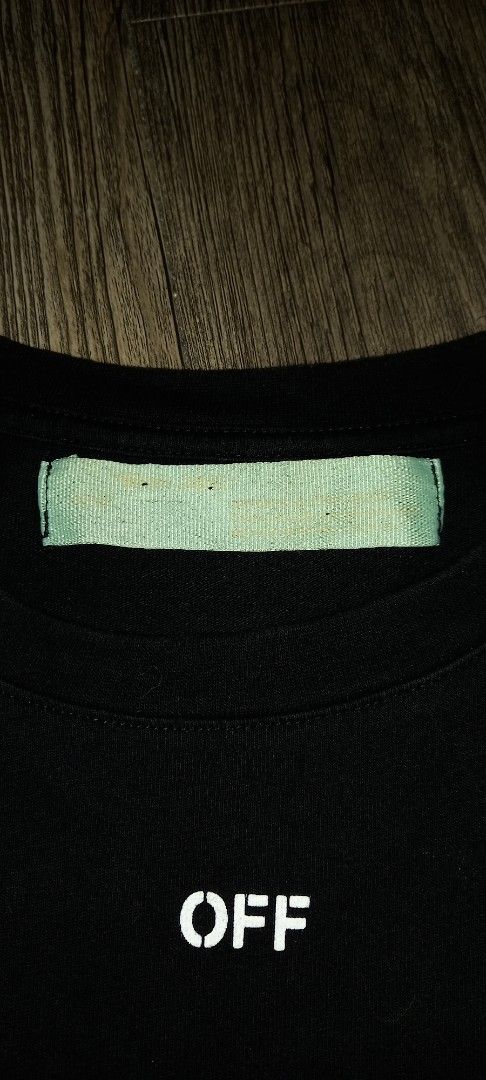 OFF-WHITE Black T-Shirt (Category: Tshirts & Polo Shirts ) located in Cavite. Submitted by chard112345 (Listing ID 1463548396, Image 3). Description: - OFF-WHITE black t-shirt. - Features the iconic OFF-WHITE diagonal arrows graphic on the front. - Small 'OFF' logo detail on the chest. - Tag details are visible in the provided photos. - A must-have addition to any streetwear collection..