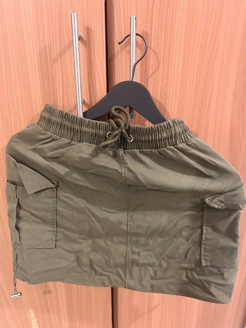 Olive Green Cargo Mini Skirt with Drawstring Waist (Category: Skirts) located in Taguig. Submitted by peanutcoconut (Listing ID 1463484930, Image 2). Description: - Cute olive green cargo mini skirt - Stretchy drawstring waist for a comfy fit - Two side pockets and two front flap pockets - Drawstring hem for adjustable fit - Ideal for casual outfits.