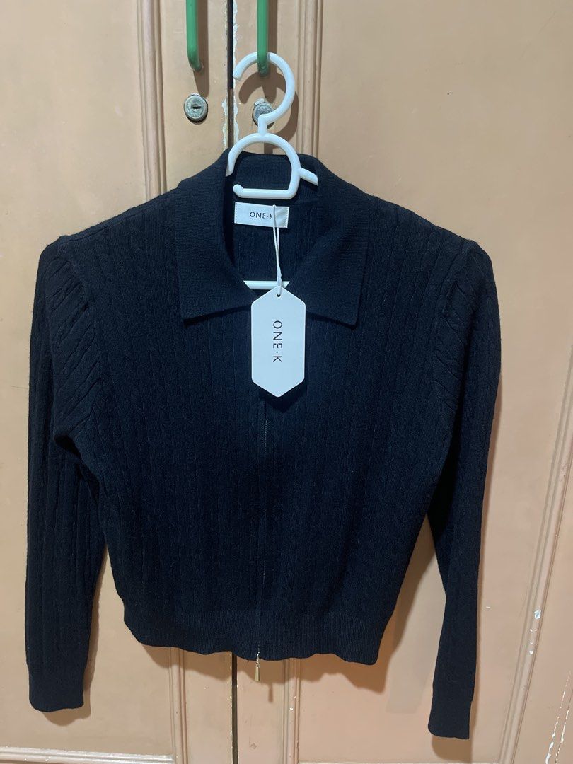 ONE-K Black Cable Knit Collared Zip-Up Cardigan (Category: Coats, Jackets and Outerwear) located in Quezon City. Submitted by donnabelle7572 (Listing ID 1463447611, Image 1). Description: - Brand: ONE-K - Color: Black - Style: Cable knit cardigan - Neckline: Collared - Closure: Zip-up front - Sleeves: Puff sleeves - Length: Cropped - Estimated Size: Small - Condition: New with original tag attached - Versatile: Great for layering or wearing alone