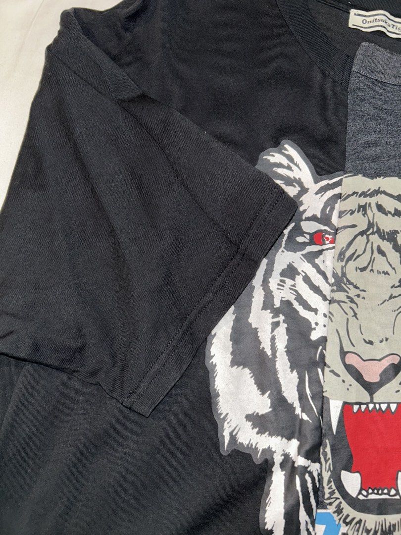 Onitsuka Tiger Graphic T-Shirt (Category: Tshirts & Polo Shirts ) located in Manila. Submitted by hyacinth1414 (Listing ID 1463466205, Image 2). Description: - Authentic Onitsuka Tiger graphic tee - Unique split design featuring a tiger graphic - Classic black and grey colorway - Ideal for everyday casual styling.