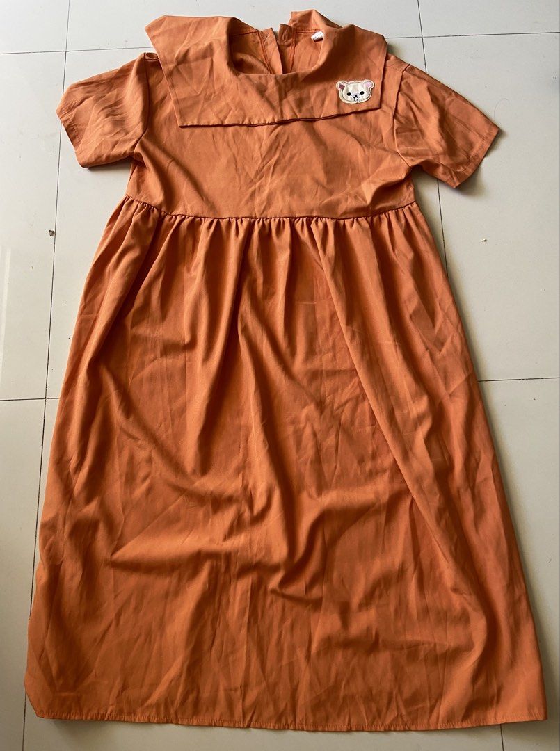 Orange A-line Dress with Sailor Collar and Bear Patch (Category: Dresses) located in Bangui. Submitted by loricam (Listing ID 1463395555, Image 1). Description: - Adorable orange dress - Features a cute sailor collar with a bear patch - Short sleeves for comfort - Elasticated waist for a flattering fit - Flowy skirt for a playful look - Likely has a back zipper for easy wear - Ideal for casual outings and everyday style.