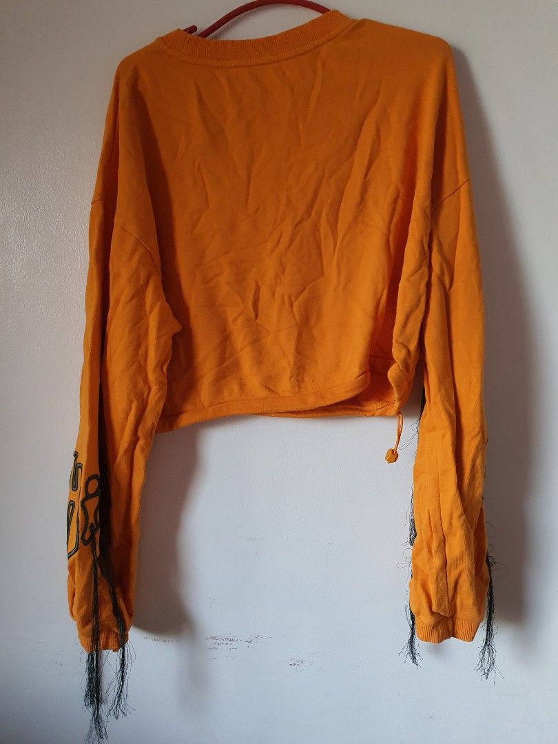 Orange Cropped Sweatshirt with Drawstring and Graphic Sleeves (Category: Longsleeves) located in Meycauayan. Submitted by shoptoown (Listing ID 1463413551, Image 2). Description: - Orange cropped sweatshirt - Long sleeves with graphic print - Frayed cuffs - Drawstring hem - 'ALWAYS KEEP' text on collar - Measurements: 15" chest, 19" length - Ideal for a casual look.