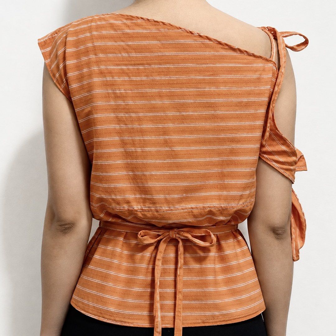 Orange Striped One-Shoulder Tie Top (Category: Sleeveless) located in Caloocan City. Submitted by irstmr (Listing ID 1463508859, Image 2). Description: upcycled top made of thrifted polo shirt 🧡 important note: have a unnoticeable white stain at the back visit @missfitsmnl on IG for more.