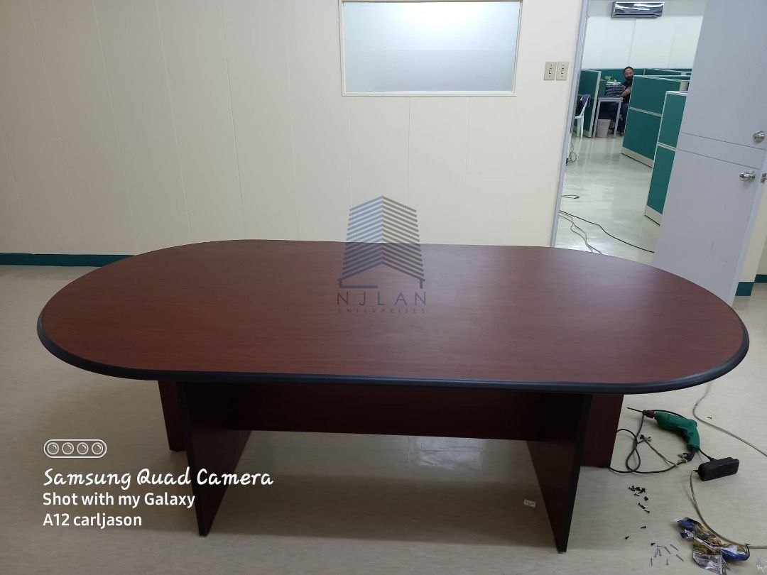 Oval Conference Table - Dark Wood Finish (Category: Office Furniture & Fixtures) located in Caloocan City. Submitted by boldwind_7b70cf (Listing ID 1463399808, Image 1). Description: - Large oval conference table - Dark wood finish with black trim - Sturdy base for stability - Perfect for office meetings or as a large dining table - Ready for its new home.