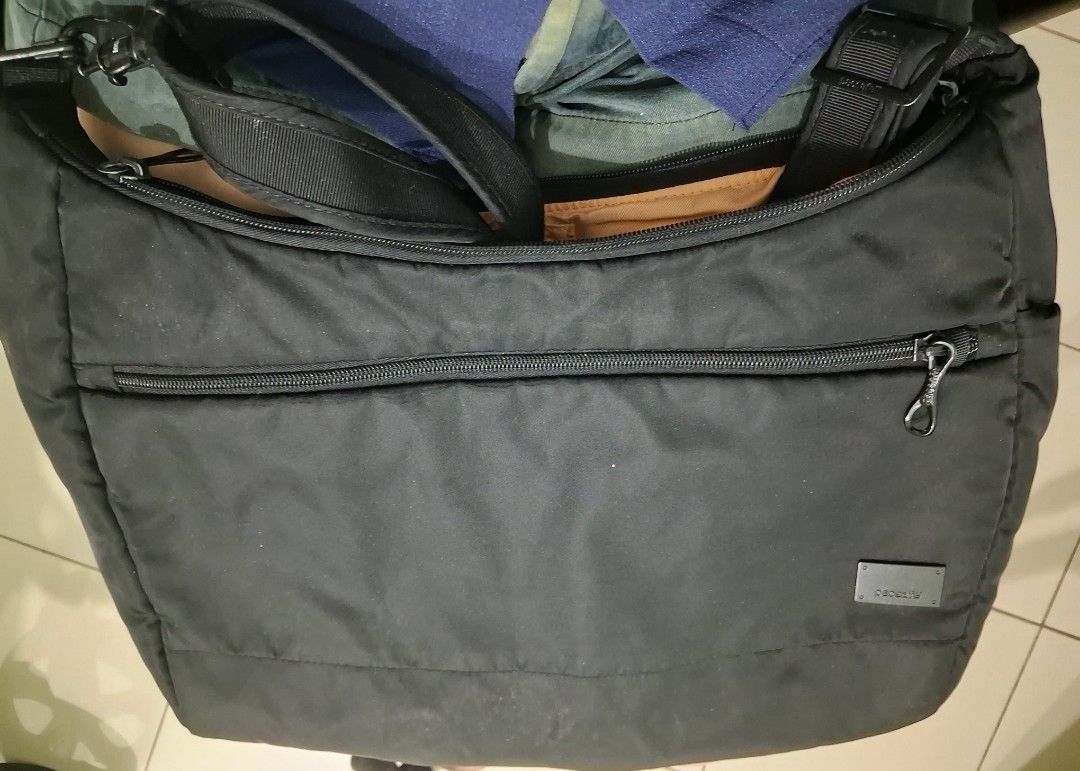 Pacsafe Black Crossbody Bag RFID Safe (Category: Cross-body Bags) located in Mandaluyong City. Submitted by gantan.tree (Listing ID 1463516645, Image 1). Description: - Brand: Pacsafe - Type: Black Crossbody Bag - Security: RFID blocking technology - Organization: multiple interior compartments - Exterior: front zip pocket, adjustable strap - Condition: good, with minor exterior marks - Ideal for: travel, laptop use Price negotiable, name your pr