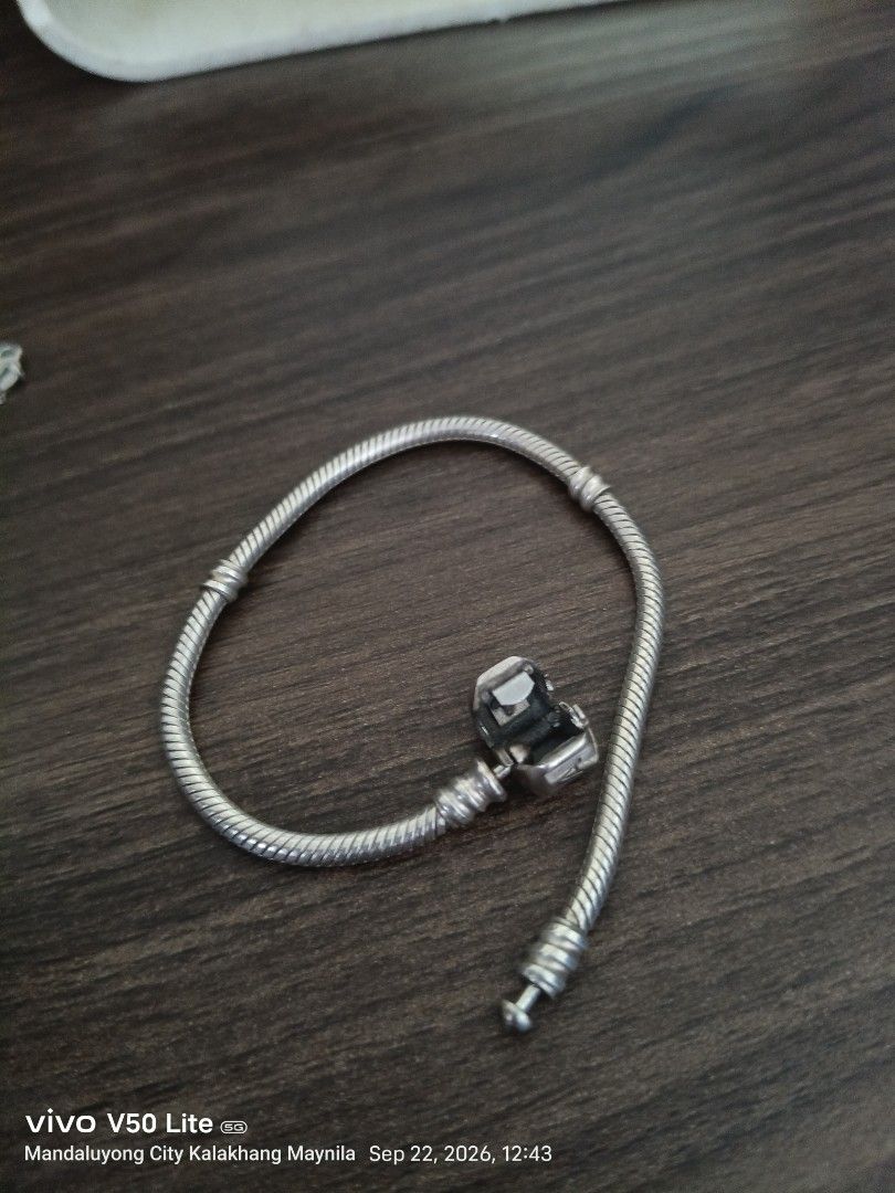 Pandora Sterling Silver Bracelet with Charms (Category: Bracelets) located in Manila. Submitted by prettylook48762 (Listing ID 1463368086, Image 2). Description: - Authentic Sterling Silver Pandora Bracelet - Classic Pandora Heart Clasp - Snake Chain Style - Comes with 3 Charms: - Filigree Ball Charm - Pandora Logo Charm - Black and White Design Charm - Ideal for adding your own personal touch.