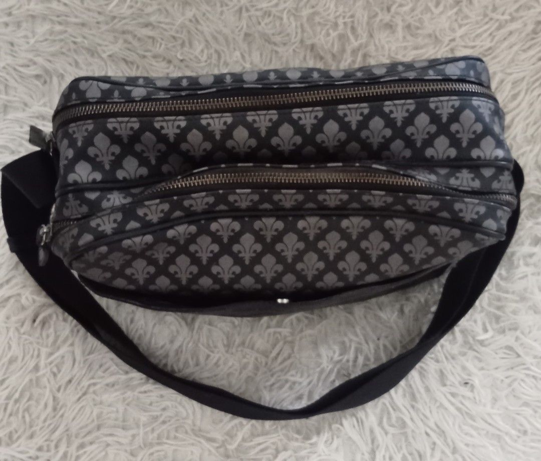 Patrick Cox Black & Grey Fleur-de-lis Crossbody Bag (Category: Cross-body Bags) located in Caloocan City. Submitted by noy5o1a (Listing ID 1463364774, Image 3). Description: - Stylish black and grey crossbody bag - Features a repeating fleur-de-lis pattern - Multiple zippered compartments for easy organization - Adjustable strap for comfortable wear - Ideal for everyday use or travel.
