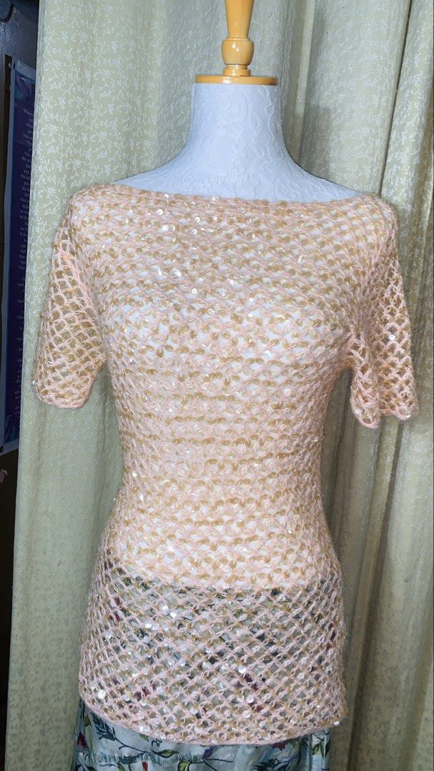 PDMS Sequin Mesh Boat Neck Top Size M (Category: Sleeveless) located in Dagupan City. Submitted by sj_styles0910. (Listing ID 1463531258, Image 1). Description: - Light pink mesh top - Adorned with gold sequins - Features a boat neck and short sleeves - Sheer material with a subtle diamond pattern - Estimated size: Medium - Versatile for layering or evening wear.